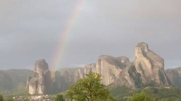 A landscape with rock formations and a rainbow.