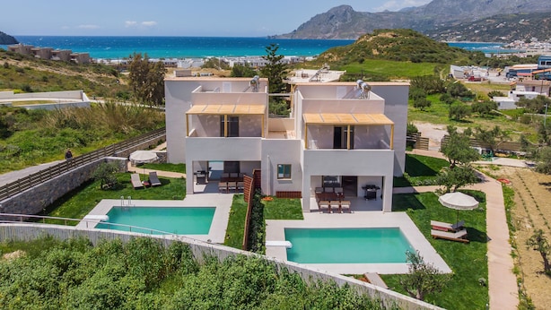 A modern two-story house with a swimming pool, a patio, and a view of the sea. - Increteblue Suites (Agios Vasileios)