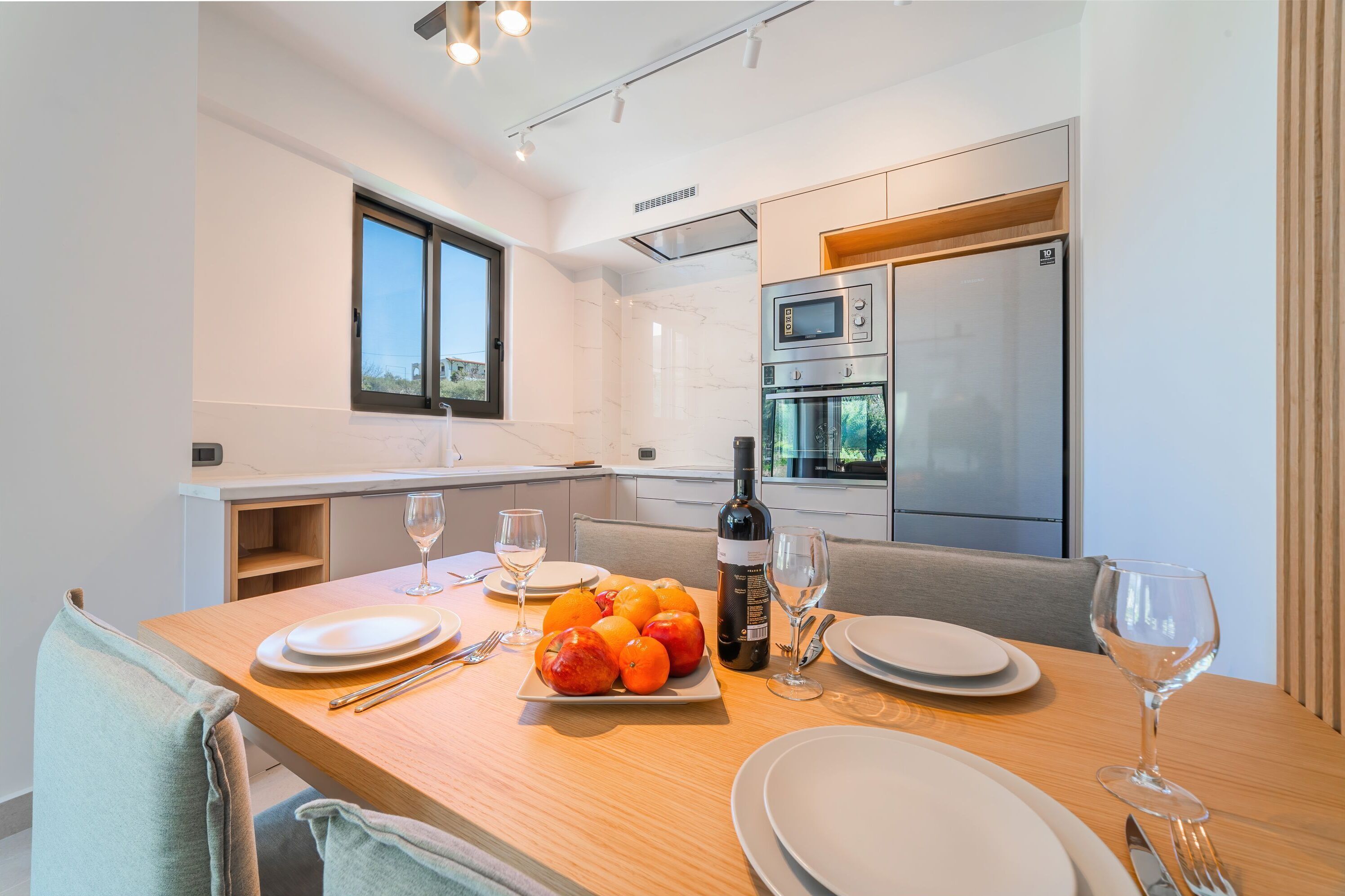 A modern kitchen with a dining area.