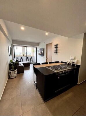 Enjoy cooking in the spacious kitchen with a central island and gas stove, perfect for preparing meals.