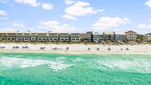 A beachfront hotel with multiple buildings, a sandy beach, and clear turquoise waters. - BellaVista on the Beach*HotTub*Gulf Front*3 Patios (Miramar Beach)