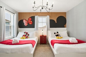 A hotel room with two beds, a chandelier, a nightstand, and a window with blinds. - 5BD Windsor Island Private Pool  (WI 1900) (Davenport)