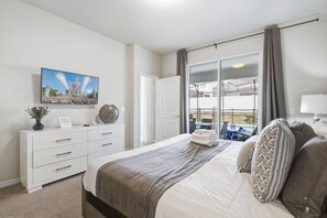 A bedroom with a bed, a dresser, a painting, and a view of a balcony. - 5BD Windsor Island Private Pool  (WI 1900) (Davenport)