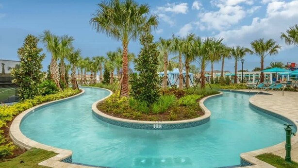 A curved swimming pool surrounded by palm trees and a covered area with lounge chairs. - 7BD Windsor Westside Near Parks (WW 2485) (Four Corners)