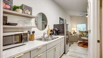 Fridge, microwave, coffee/tea maker, cookware/dishes/utensils