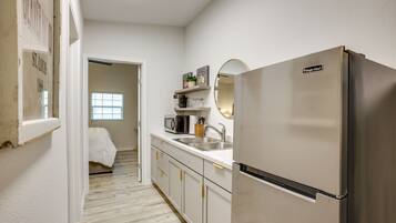 Fridge, microwave, coffee/tea maker, cookware/dishes/utensils
