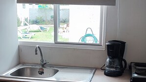 A small kitchen with a sink, a coffee maker, and a window with a view of the outside. - Comfy Stay for 2 @CasaSanAlfonso Room #21 (San Alfonso)