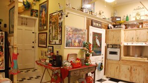 Una cocina con piso a cuadros, gabinetes de madera y varios electrodomésticos.