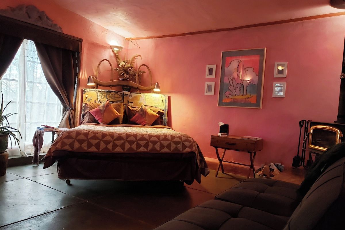 This adobe casita has a queen  bed with Egyptian cotton sheets, handmade vintage quilts and a cozy wood stove.