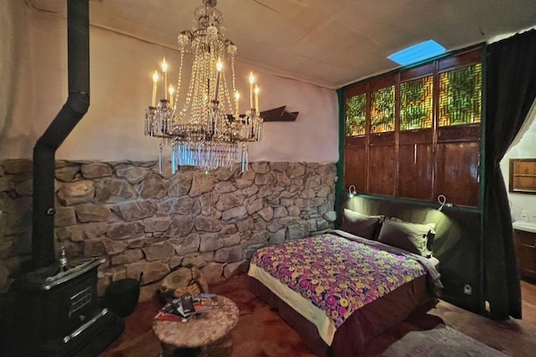 A Queen bed with Egyptian sheets, woode stove and walk in rock shower awaits in this romantic carriage house located on an historic property.