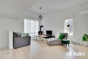 Cozy living space with a fireplace, flat-screen TV, and comfortable seating area.
