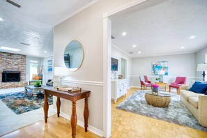 Ein geräumiges Wohnzimmer mit Kamin, Essbereich und Küche.