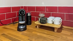 A kitchen with a coffee maker, a kettle, and a tray with cups. - 1 bedroom accommodation in Adversane, near Billingshurst (Adversane, near Billingshurst)
