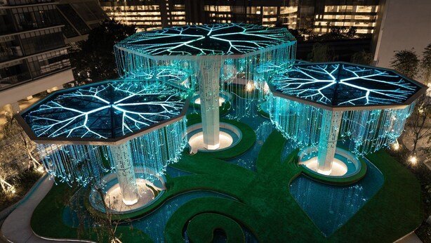 A modern building with multiple illuminated structures featuring geometric patterns and hanging lights. - Arte plus KLCC By Tenang Home (Kuala Lumpur)