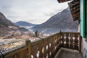 Een balkon met uitzicht op een vallei en bergen.