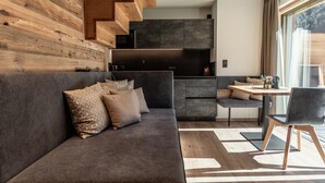 A modern kitchen with dark cabinets and a built-in microwave.