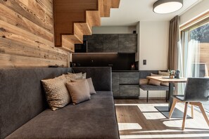 A modern kitchen with dark cabinets and a built-in microwave.