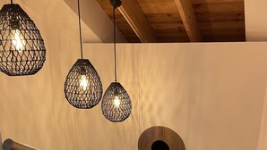 A staircase with a metal railing, a wooden ceiling, and hanging pendant lights. - Maison Plein Centre, Idéale Pour un Couple (Pont-l'Abbé)