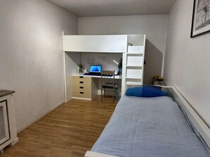 A compact room with a bunk bed, a desk with a computer, and a small chair. - TOP Appartment Nähe Schalke Stadium, Veltins Arena ist 10 min zu Fuß Entfernt (Gelsenkirchen)