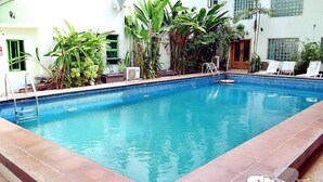 A rectangular indoor swimming pool with clear blue water, surrounded by a tiled edge. - The Dover Hotel Lekki (Lekki)