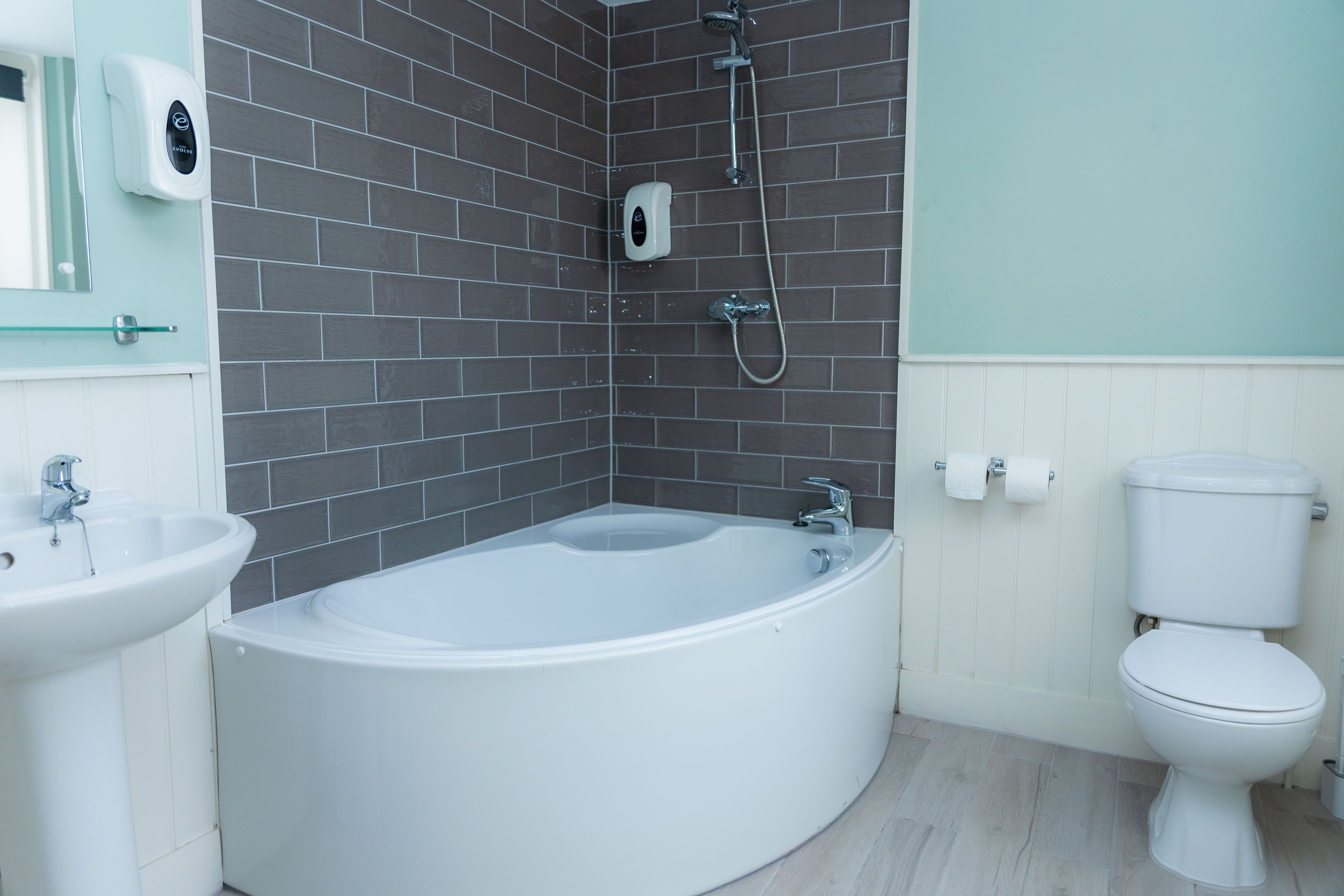 A modern bathroom with a freestanding bathtub, a sink, and a toilet.