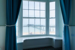 A room with a bay window overlooking a pier and beach. - The Clarendon Hotel (Deal)