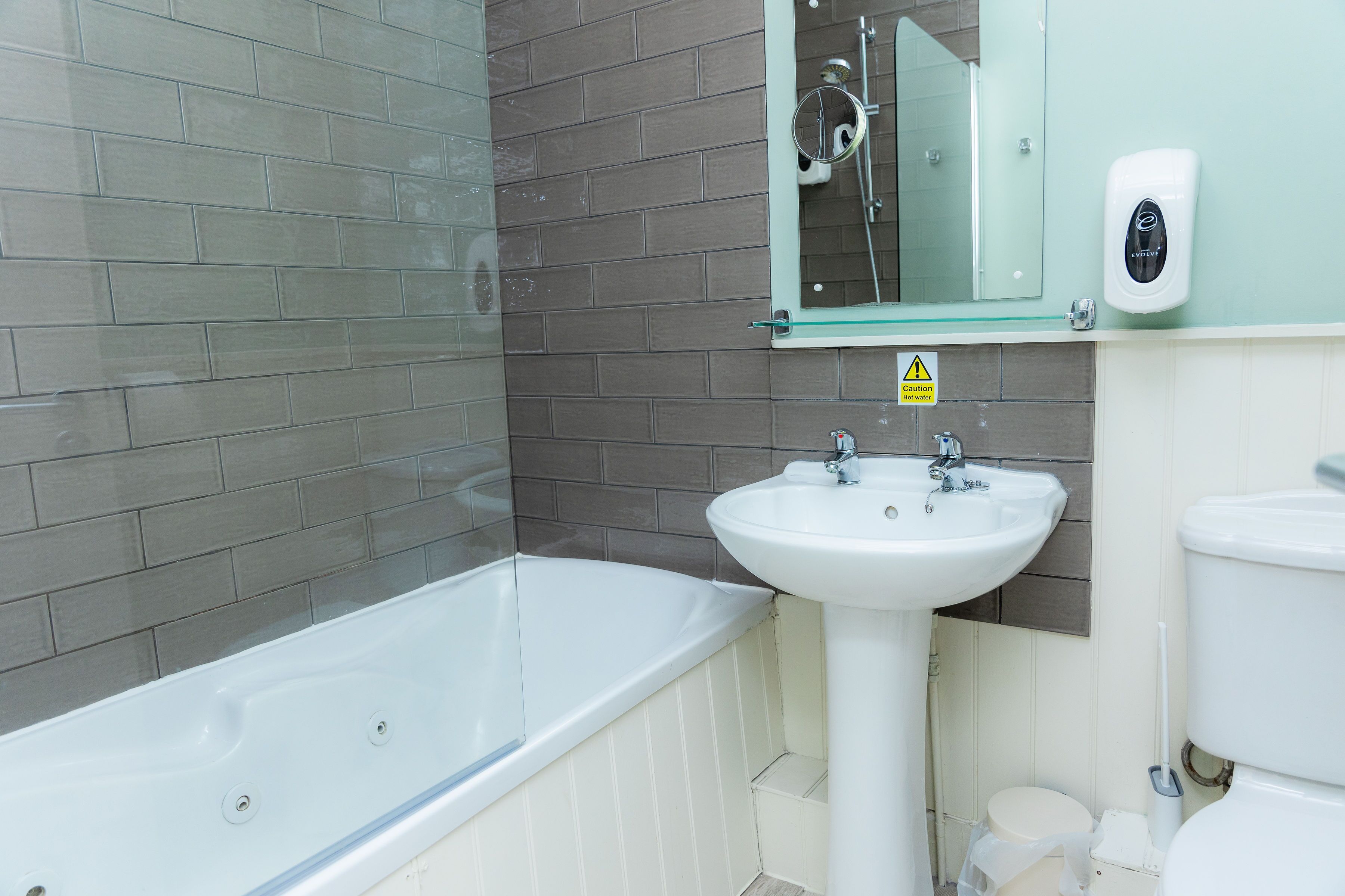 A bathroom with a bathtub, sink, and toilet.