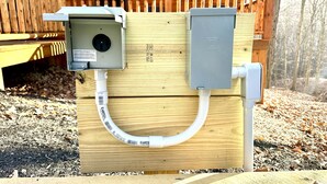 A wooden structure with electrical boxes and a conduit. - Blue Bird | Luxury Cabin in the Woods (Logan)