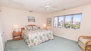 A bedroom with a bed, two bedside tables with lamps, a window with a view, and a ceiling fan. - Oceanside, Community Pools, Community Tennis, 628,  Corolla Time (Corolla)
