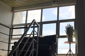 A staircase with a metal railing leading to a window with multiple panes. - B Boutique Hotel Cebu powered by Cocotel (Lapu-Lapu)