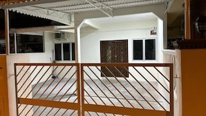 A gated entrance to a building with a covered patio area. - Bukit Tinggi Homestay (Klang)