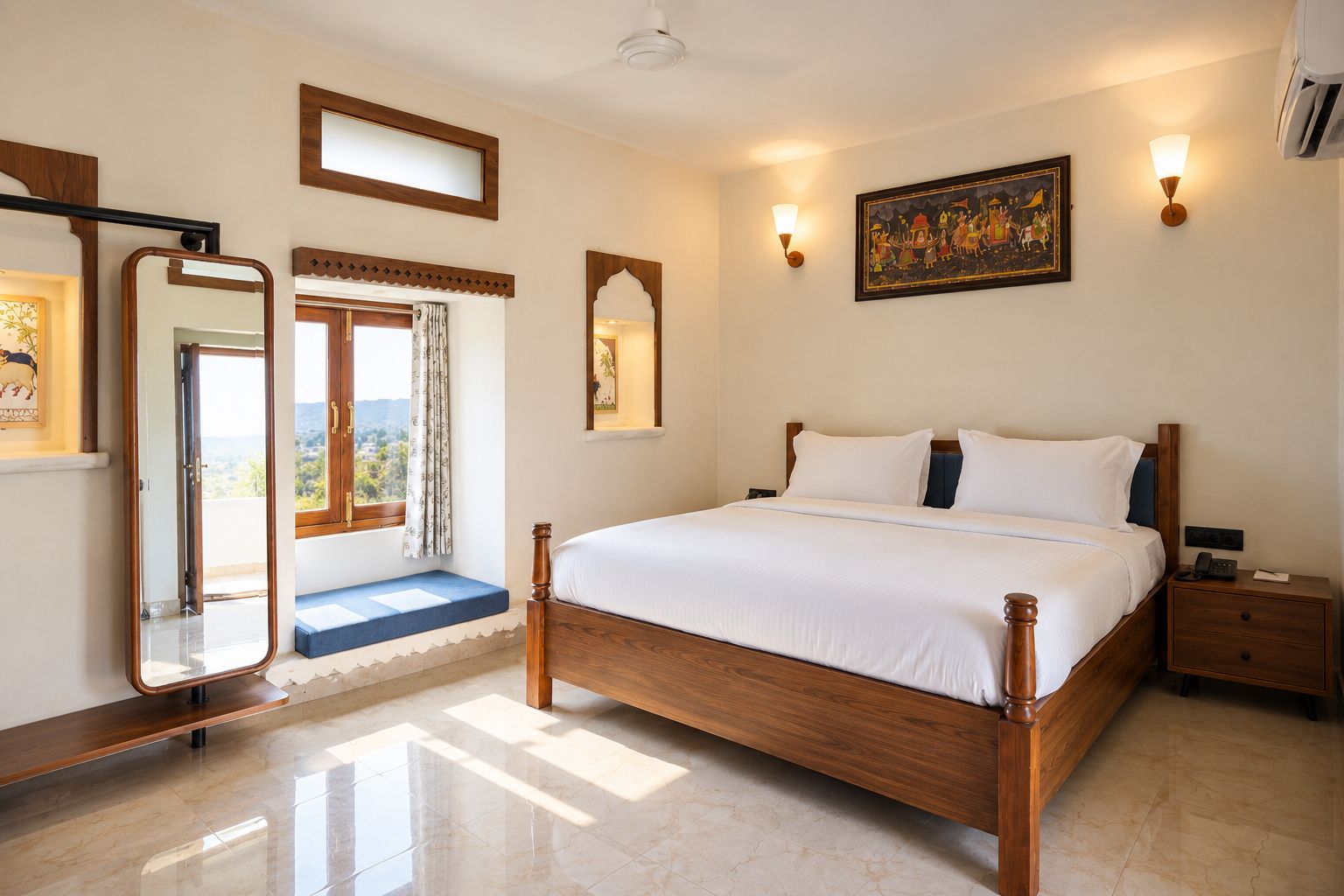 A bedroom with a large bed, a bedside table, a nightstand, a mirror, and a window with a view.