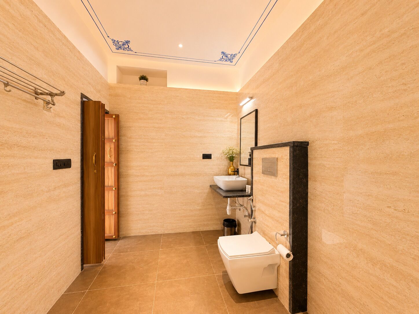 A modern bathroom with a toilet, sink, and mirror.