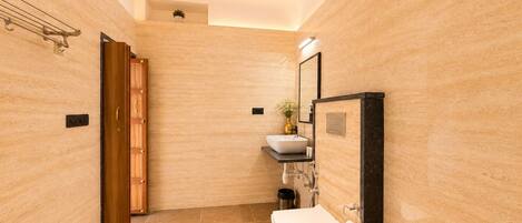 A modern bathroom with a toilet, sink, and mirror.