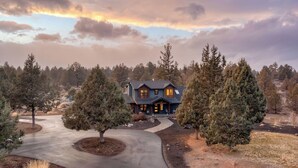 A two-story house with a driveway, surrounded by trees. - The Gem Estate by Avantstay Modern Farmhouse w/ Lavender Fields + Hot Tub (Bend)