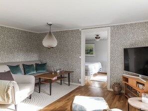 A modern living room with a sofa, coffee table, and TV stand. - Skjutsmåla by Interhome (Olofström)