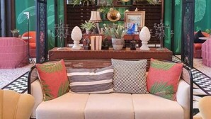 A cozy living area with a sofa, coffee table, and decorative items.