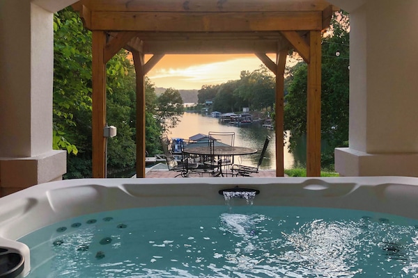 Soak in the hot tub overlooking the serene cove.