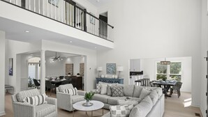 A spacious living room with a high ceiling, a dining area, and a kitchen. - Knotty Pines by AvantStay | Lake Views, Renovated (Sherrills Ford)