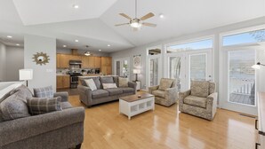 A spacious living area with a sofa, armchairs, a coffee table, and a ceiling fan. - Kool Breeze by AvantStay | Boat Ramp + Hot Tub (Denver)
