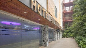 A hotel with a modern facade, large glass windows, and a wooden overhang. - Hotel All Time Residency - Near Connaught Place New Delhi (New Delhi)