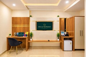 A hotel reception area with a reception desk, a seating area, and a refrigerator. - Hotel All Time Residency - Near Connaught Place New Delhi (New Delhi)