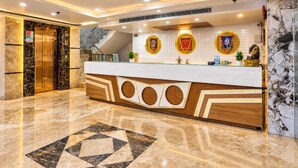 A hotel reception area with a marble floor, a reception desk, and a staircase. - Hotel All Time Residency - Near Connaught Place New Delhi (New Delhi)