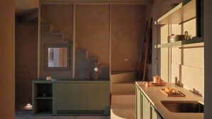 A modern kitchen with a built-in stove, a sink, and a wooden countertop.