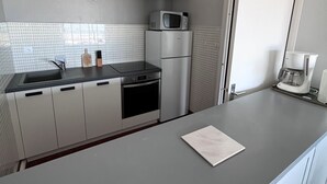 A modern kitchen with a stainless steel refrigerator, microwave, and coffee maker.