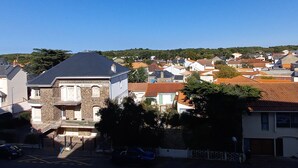A residential area with houses, a street, and a clear blue sky.