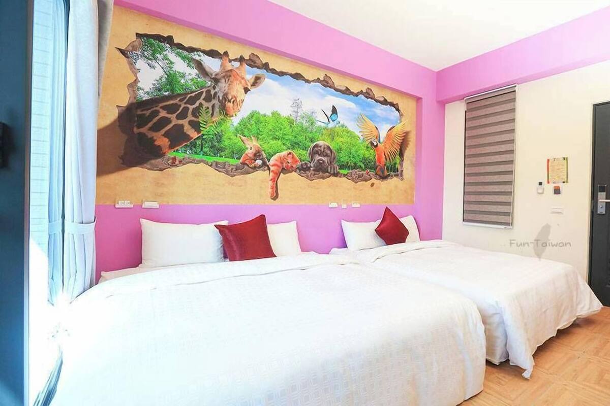 A room with two beds, a mural of animals on the wall, and a door with a rose design.