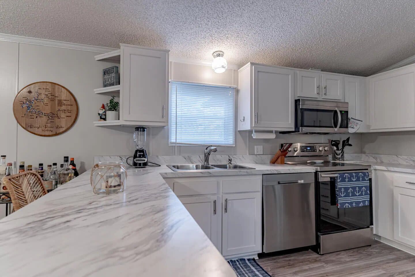 Kitchen: The white cabinetry offers ample storage, and the kitchen island is perfect for a quick snack or a morning cup of coffee.