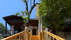 A wooden staircase leading to a building with a balcony. - My Antalya (Antalya)