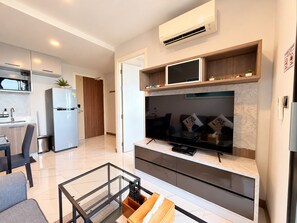 A modern kitchen with a built-in microwave, refrigerator, and a wooden cabinet above the countertop. - BO202- 1 Bedroom Serviced Apartment With Sea View at Ao Nang Beach (Tambon Ao Nang)